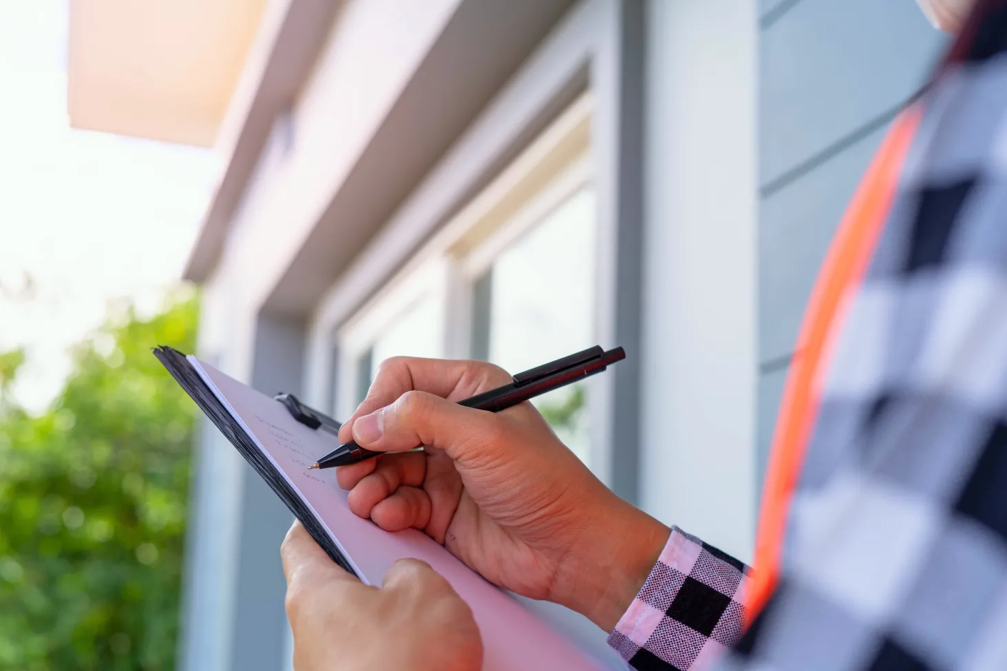 Roofing contractors reviewing roof inspection documents for insurance and real estate purposes