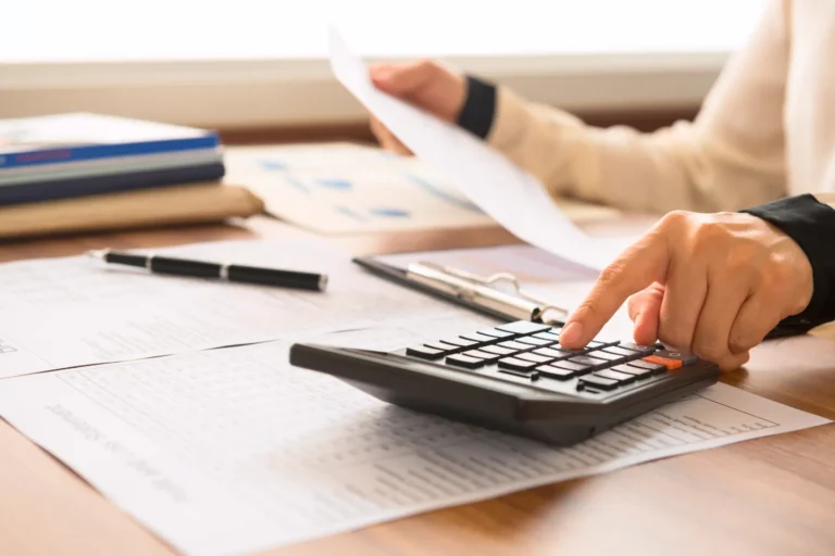 Homeowner calculating roof repair and water damage restoration costs after a roof leak