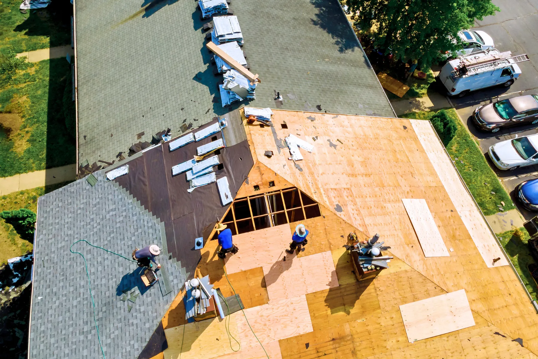 Aerial view of a complete roof tear-off and replacement project showing exposed roof decking before installation of new roofing materials.