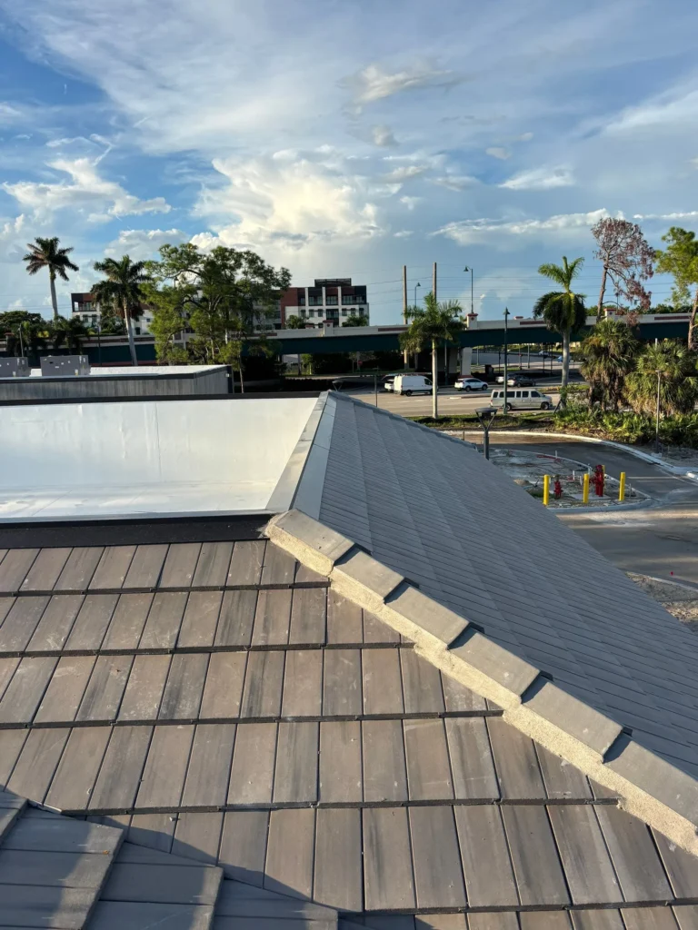 Plaza Halstatt concrete tile roofing beside the white TPO roof system